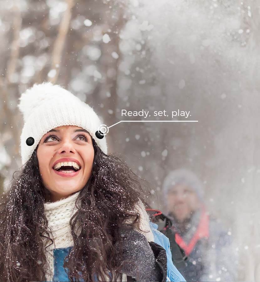 Happy woman wearing Beanie Buttons on her ski hat